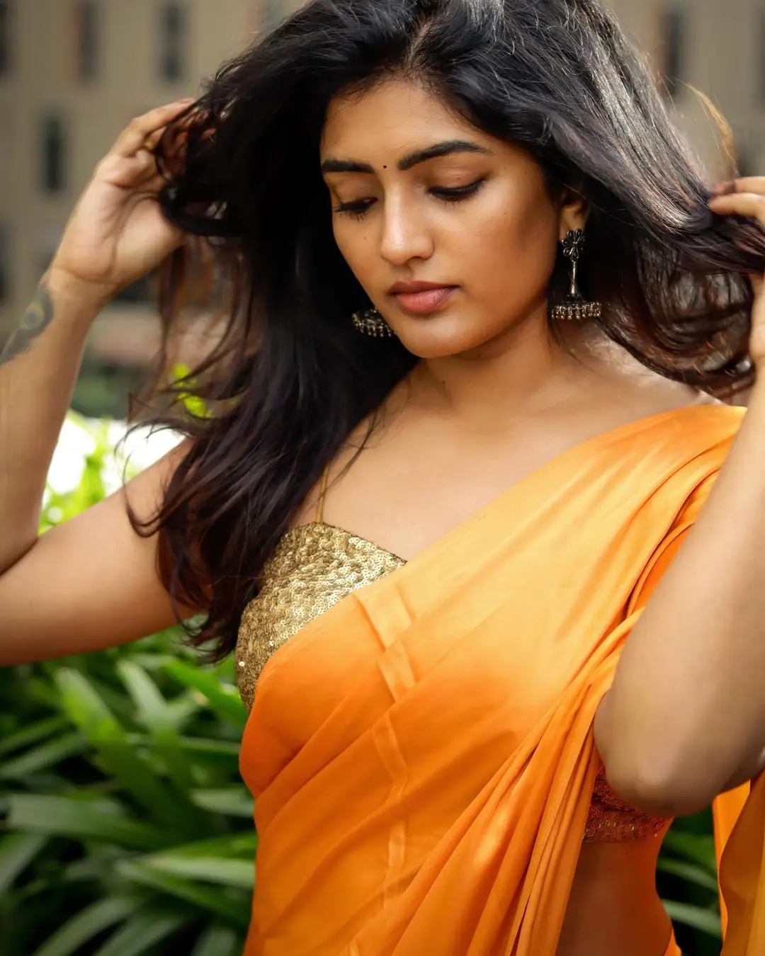 Eesha Rebba Charming Stills In Orange Saree Sleeveless Blouse